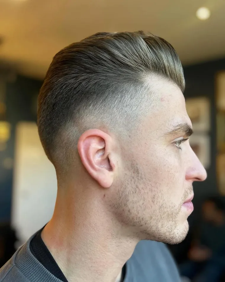 A slick-back with a high skin fade, finished at Butler’s Barbering